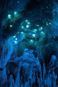 the inside of a cave lit up with lights