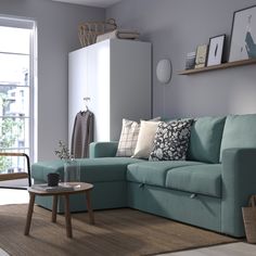 a living room with a blue couch and coffee table in front of a large window