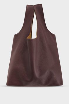 A large burgundy tote shoulder bag made of fine Italian grain leather. The bag is suited as a work bag or a travel bag. Modern Reversible Bags For Everyday Use, Modern Reversible Shoulder Bag, Versatile Reversible Hobo Tote Bag, Daily Use Reversible Hobo Bag With Double Handle, Versatile Reversible Hobo Bag For Everyday Use, Reversible Brown Shoulder Bag For On-the-go, Everyday Reversible Brown Bag, Brown Reversible Shoulder Bag For On-the-go, Reversible Double Handle Hobo Bag For Everyday Use