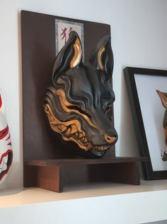 a dog's head is on top of a shelf next to two other items