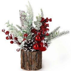 a vase filled with lots of red and white decorations on top of a wooden stump