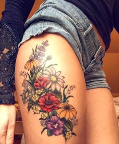 a woman's thigh with flowers on it