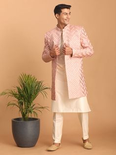 Vastramay Men's Pink Mirror Indo Western Sherwani with Kurta Pyjama Set Look impeccably stylish in this pink mirror work Sherwani set. Featuring a trendy Indo-Western design, the Sherwani boasts intricate mirror work and a mandarin collar, while the Kurta and Pyjama complement perfectly. Key Features Aqua blue mirror work design on Sherwani Mandarin collar, full sleeves on Sherwani, Kurta & Pyjama Cream colored Kurta and Pyjama Elasticated waistband with button closure on Pyjama Specifications S Designer Gota Work Kurta For Eid, Pink Kurta For Reception And Transitional Season, Pink Kurta For Eid Reception, Designer Pink Kurta With Resham Embroidery, Pink Bandhgala With Chikankari Embroidery, Traditional Long Sleeve Pink Bandhgala, Traditional Pink Long Sleeve Bandhgala, Long Sleeve Pink Kurta With Gota Work, Pink Resham Embroidered Bandhgala For Formal Occasions