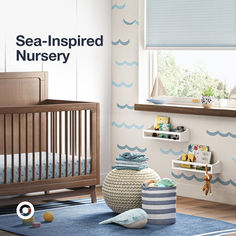 a baby's room with blue and white decor