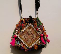 Elevate your style with our exquisite handmade Banjara embroidery patch sling crossbody bag - a true embodiment of Indian craftsmanship and boho charm. This ethnic crossbody bag is not just an accessory; it's a celebration of rich artistry and the skill of our talented artisans in India. Adorned with a cute Banjara tassel, this bag seamlessly blends the traditional with the contemporary, making it your perfect everyday companion. The Banjara fabrics used in this creation are not merely materials; they are highly collected pieces that tell a story of tribal heritage. The intricate vintage Jat mirror work embroidery adds a touch of uniqueness and authenticity to this bag. It's more than just a bag; it's a piece of tribal art that you can carry with you wherever you go. The handwork is eviden Sling Crossbody Bag, Authentic Indian, Embroidery Patch, Handmade Gift Wrap, Unique Bags, Handmade Bag, Boho Bag, Bag Handmade, Embroidery Patches