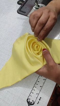 someone is making a flower out of fabric