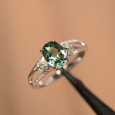 It is a green sapphire ring. The main stone is 6 mm*8 mm oval cut.weight about 1.75 carats. The basic metal is sterling silver and plated with rhodium/14k white gold/14k rose gold/14k yellow gold You can also go to my shop Home for more elegant rings: https://www.etsy.com/shop/godjewelry?ref=hdr_shop_menu Customization is always welcome and please feel free to contact with me if you have any design ideas! Green Stone Ring Engagement, Green Engagement Ring Silver, Green Wedding Rings, Green Engagement Rings, Wedding Ring Oval, Elegant Rings, Drawing Designs, Silver Promise Rings