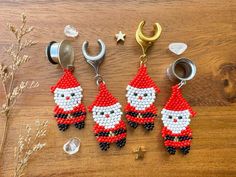 three beaded christmas ornaments are sitting on a table next to scissors and other items