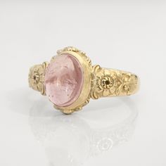 This vintage style peony-themed signet ring, featuring beautiful little peony flowers and leaves with fluorishes all around the center which displays a lovely pink tourmaline cabochon.  This ring can be customized with any letter or word (provided it fits) and is made in solid gold. This ring can be made for men or women and in your preferred size or color of gold. A phrase or letter may be written on the inside, too! Measurements: 10 x 12mm Material: 8K or 14K solid gold (rose, white or yellow) Luxury Vintage Cameo Signet Ring, Vintage Flower Shaped Jewelry With Rose Cut Diamonds, Vintage Birth Flower Rings For Anniversary, Vintage Gemstone Flower Promise Ring, Vintage Flower Ring With Gemstone, Vintage Rose Design Rings For Wedding, Vintage Flower Shaped Gemstone Ring, Vintage Wedding Rings With Rose Design, Vintage Rose Design Wedding Rings