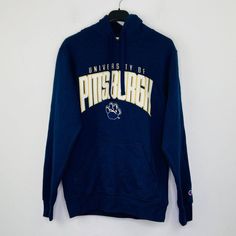 Approximate Measurements: Length 27 In., Width 19 In. (Armpit To Armpit). Flaw: Small Stain On One Of The Sleeves. Navy Hoodie With Embroidered Logo For Fall, Blue Hoodie With Embroidered Logo For College, Blue Hoodie With Embroidered Logo For Winter, Blue Hoodie Sweatshirt For Fans, Blue Long Sleeve Sweatshirt For Fans, Winter Blue Sweatshirt For Sports Fans, Blue Winter Sweatshirt For Fan Gear, Blue Hoodie With Letter Print For Fans, Winter Cotton Sweatshirt With University Logo