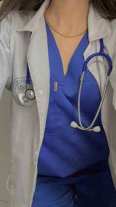 a close up of a person wearing a doctor's coat and holding a stethoscope