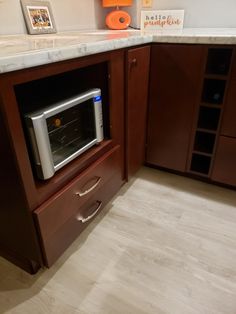 an oven built into the corner of a kitchen countertop with drawers and cupboards