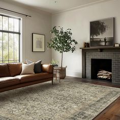 a living room filled with furniture and a fire place in front of a large window