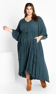 Drape your curves in the flowy Cadence Dress, offering a beautifully bohemian aesthetic. This dress can be styled up or down depending on the occasion, with sleeved coverage and a dreamy maxi hemline. Key Features Include: - V-neckline - Decorative buttons on bodice - Elbow length bell sleeves - Drawstring waist - Ruffle detailing on skirt - Lace embellishments - Relaxed silhouette - Unlined Keep it cool and casual in a tassel handbag and heeled boots. | Plus Size Cadence Aegan Dress in Aegean, Explore City, Denim Short Dresses, Lace Inset, Decorative Buttons, Ruffled Maxi Dress, Plus Size Maxi Dresses, Overall Dress, City Chic, Buy Dress