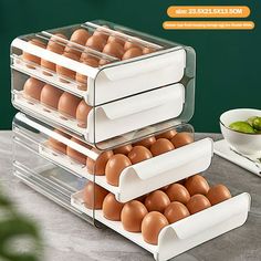 three tiered trays filled with eggs sitting on top of a table next to bowls and utensils