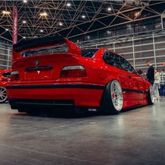 a red car parked inside of a building