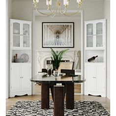 a dining room table with chairs and a chandelier