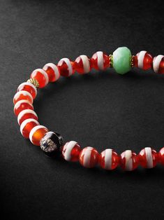 Ileana Marki's colourful, creative designs draw on the designer's travels and Greek mythology. This bracelet is strung with vibrant striped agate and gold charms alongside beads encrusted with diamonds, one of which is designed to resemble an evil eye. It'll make every outfit look more artfully curated. Artisan Red Beaded Bracelets With Round Beads, Artisan Red Beaded Bracelets, Traditional Red Bracelets With Polished Beads, Traditional Red Gemstone Beads Bracelet, Unique Hand-strung Red Bracelets, Traditional Red Gemstone Beaded Bracelets, Unique Hand-strung Red Beaded Bracelets, Red Rondelle Gemstone Beaded Bracelets, Unique Red Bracelets With Natural Stones