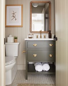 a bathroom with a sink, toilet and mirror