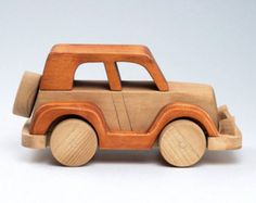 a wooden toy car is shown on a white background