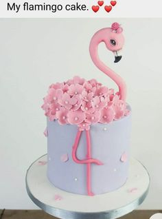 a pink flamingo cake sitting on top of a table