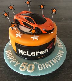 a birthday cake with an orange sports car on top and stars around the edges that say happy 60th