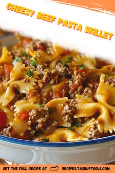 a close up of a plate of food with pasta and meat in it on an orange background