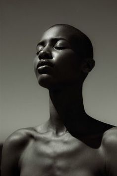 a black and white photo of a woman with her head tilted to the side looking up