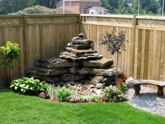 a backyard with a wooden fence and stone steps leading up to the back yard area