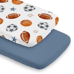 an image of a baby bed with sports themed sheets and pillow set on it's side