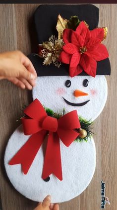 someone is making a snowman decoration out of felt and fabric with poinsettis