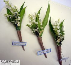 three bouquets of flowers are arranged on a piece of paper