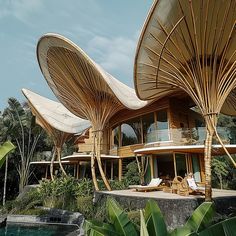 the house is made out of bamboo and has two large umbrellas on it's roof