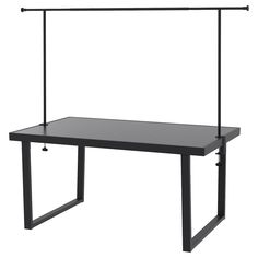 a black table with two metal bars on the top and an empty shelf below it