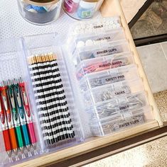 the drawers are organized with pens, markers and pencils