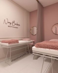 a room with two beds and mirrors on the wall, one bed has a pink rug on it