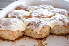 a close up of food in a pan with white sauce and icing on it