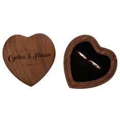 a wooden heart shaped box with a wedding ring inside and engraved on the front side