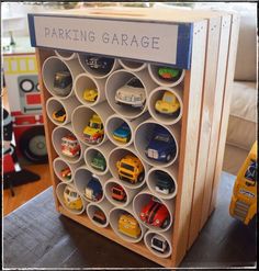 a toy truck is parked in front of a parking garage sign with cars and trucks on it