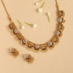 About the jewelry The videni antique necklace set is symbolic of a heritage of excellence and attention to detail. The CZ stones and antique plating come together to create the most impressive of looks no matter the occasion. Wear this with a beige suit and a Tarinika Maang Tika for the most elegant evening. At Tarinika, our designers craft modern Indian jewelry for women at the best price just like Videni. Buy with confidence now. Details & Specifications: Materials used: CZ stones with Antique Gold Necklace Women Indian, Small Gold Necklace Set Indian, Temple Jewelry Necklace Antique Gold, Necklace Design Ideas, Modern Necklace Design, Modern Indian Jewelry, Gold Necklace Design, Women Gold Necklace, Small Necklaces