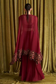 Ruby red asymmetric long cape with floral embroidered hem. Paired with an inner blouse with floral jaal embroidery. Comes along with a rounded hem sharara - Aza Fashions Cape Sharara, Jaal Embroidery, Velvet Embroidery, Long Cape, Embroidered Hem, Embroidery Floral, Sharara Set, Set For Women, Floral Blouse