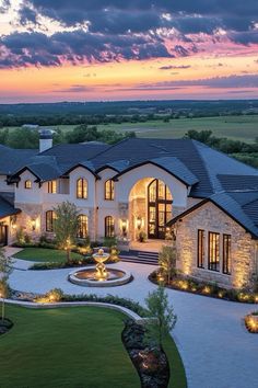 an aerial view of a large home at dusk