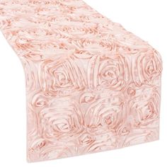 a pink table runner with roses on it