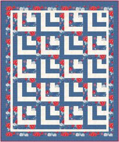 a blue and white quilt with red flowers on it