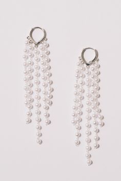 These pearl fringe hoop statement earrings are ready to party. Light and airy, full of movement, they will dance on your ears!Dimensions: Hangs 4" Materials: Simulated pearls, Alloy, 18k Gold Plating. Lever back closure.Ships in a branded jewelry pouch and box, perfect for gift giving! Fringe Hoop Earrings, Pearl Fringe, Pearl Statement Earrings, Prom 2024, Lovely Earrings, Silver Pearls, Jewelry Pouch, Long Earrings, Gift Giving