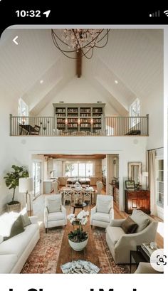 a living room filled with furniture and a chandelier hanging from the ceiling above it