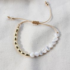 D E T A I L S: • 18k Gold Filled • Cord free to adjust (8 - 12") …………………………………. M A T E R I A L S: • Beads (3mm) • Heart (5cm) • Beige cotton cord • All sourced from USA White Jewelry With Adjustable Cord For Everyday, White Beaded Bracelets With Adjustable Chain, Adjustable White Beaded Bracelet, Dainty White Jewelry With Sliding Knot, White Jewelry With Adjustable Cord, Velvet Clutch, Ball Bracelet, Cotton Cord, Canvas Bag