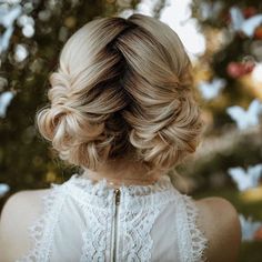 the back of a woman's head, with her hair in a low bun