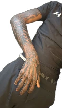 a man with tattoos on his arm and hand