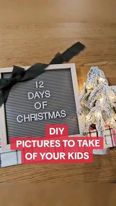 a wooden table topped with a chalkboard and christmas tree next to it's message